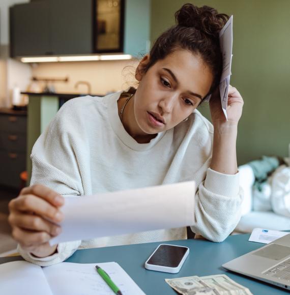 Woman looking at household bills