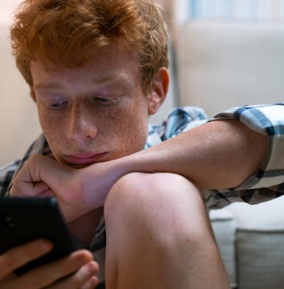 Teenage boy on his phone