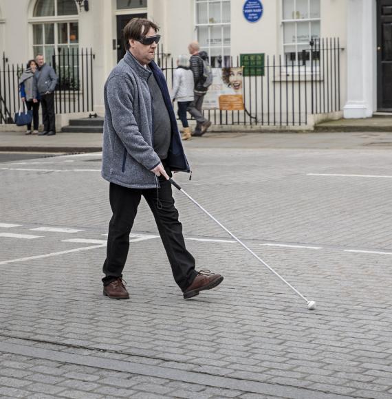 Blind man crossing the road in London
